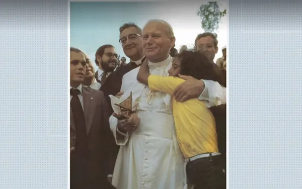 A menina que abraçou João Paulo II, durante sua visita ao Brasil, foi Lucimeire de Jesus, em Salvador, em 1980. Ela tinha 12 anos na época e entregou um barquinho de madeira ao Papa